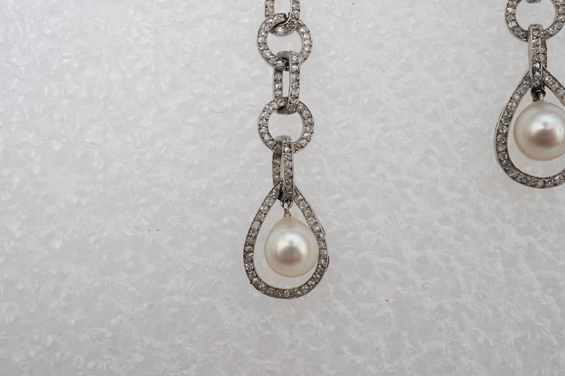 Attributed to Maurice Robin & Cie, a fine and rare pair of Art Deco natural pearl and diamond earrings, Paris, circa 1920